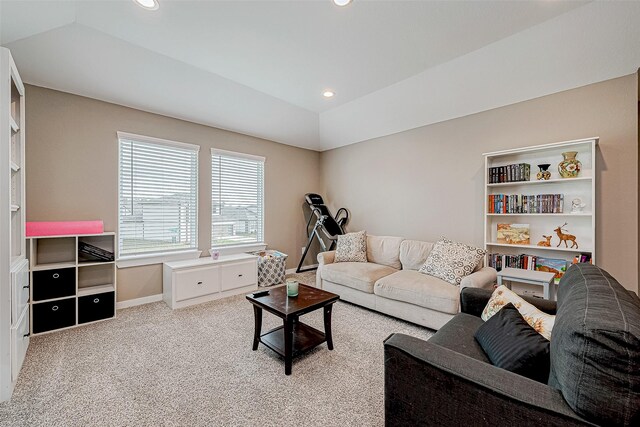 living room featuring lofted ceiling, a tray ceiling, and light colored carpet