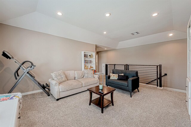 carpeted living room featuring vaulted ceiling