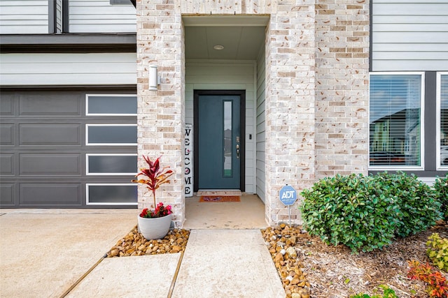 view of exterior entry featuring a garage