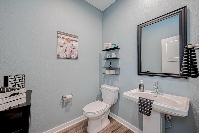 bathroom featuring hardwood / wood-style floors and toilet