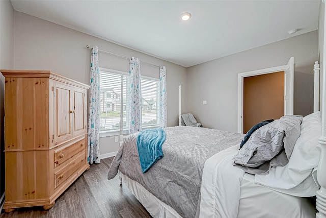 bedroom with dark wood-type flooring