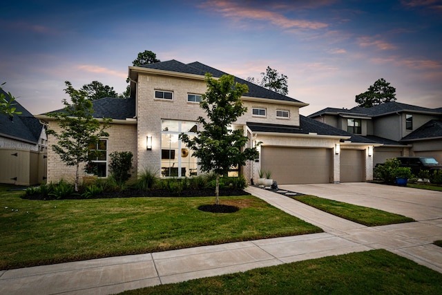 view of front of house featuring a lawn and a garage