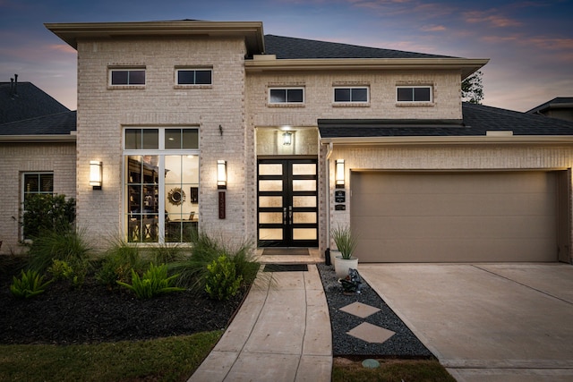 view of front of home with a garage and french doors