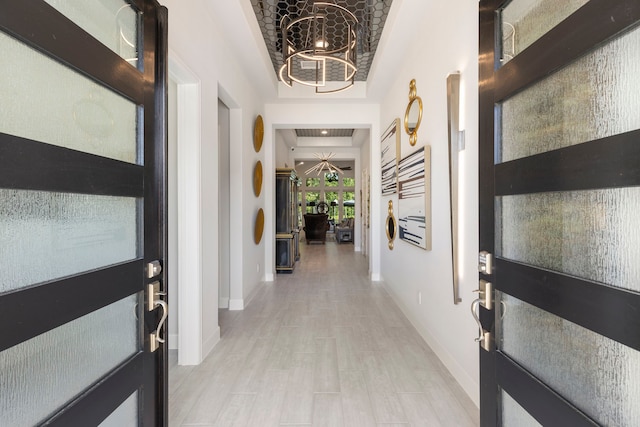 foyer featuring an inviting chandelier and light hardwood / wood-style flooring