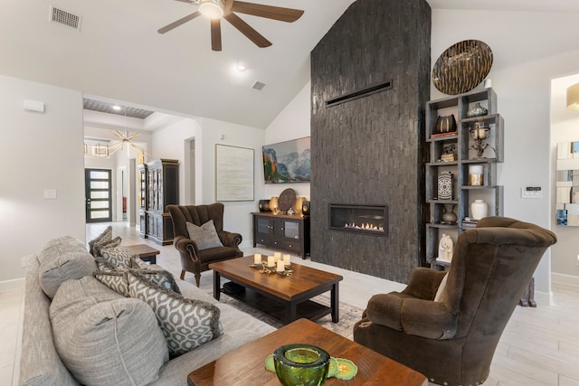 living room featuring a fireplace, high vaulted ceiling, and ceiling fan