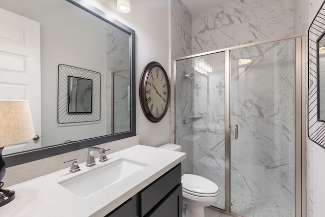 bathroom featuring vanity, an enclosed shower, and toilet