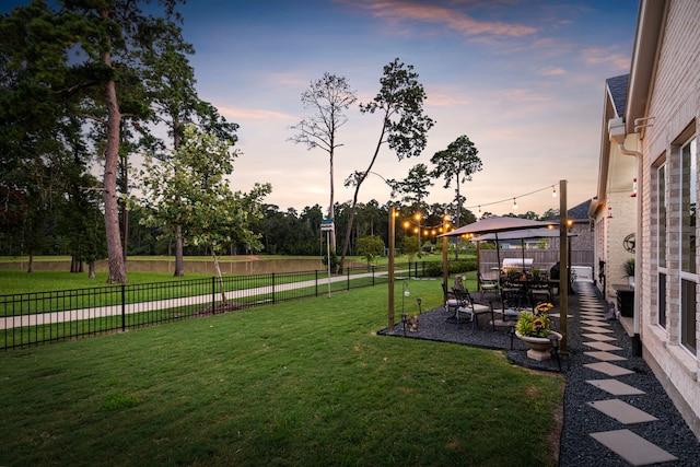 yard at dusk with a gazebo