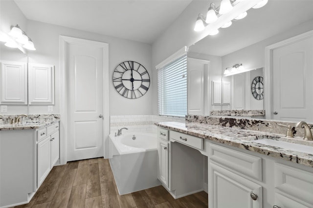 bathroom with vanity, a bathtub, and hardwood / wood-style floors