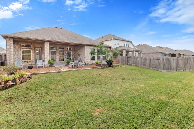 rear view of property featuring a patio area and a lawn