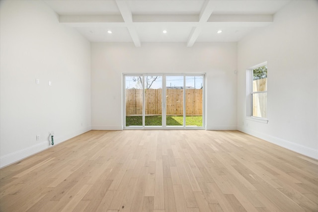 unfurnished room with beamed ceiling, light hardwood / wood-style floors, and coffered ceiling