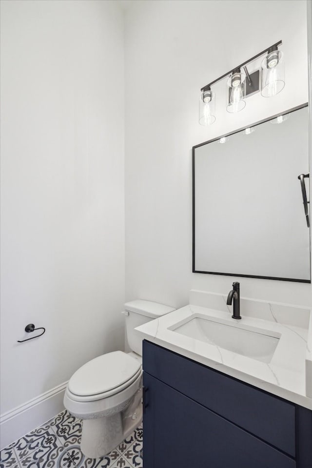 bathroom featuring tile patterned floors, vanity, and toilet