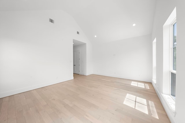 unfurnished room with light hardwood / wood-style flooring, high vaulted ceiling, and a healthy amount of sunlight