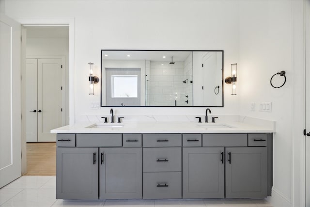 bathroom featuring tile patterned flooring, vanity, and an enclosed shower