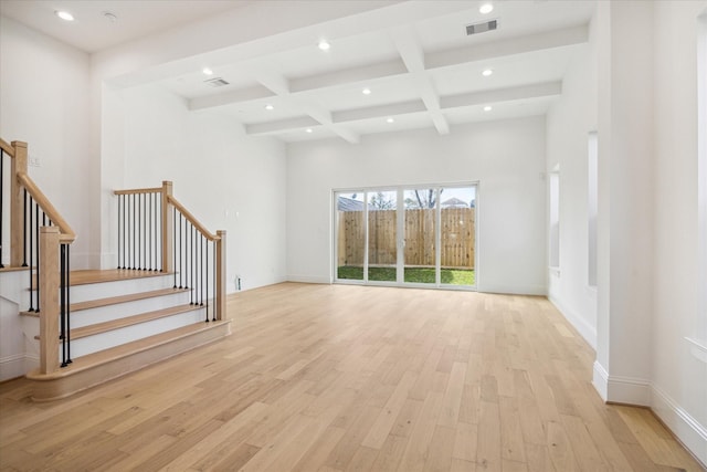 unfurnished living room featuring beamed ceiling, light hardwood / wood-style floors, and coffered ceiling