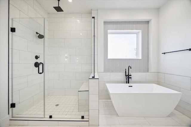 bathroom with tile walls and plus walk in shower