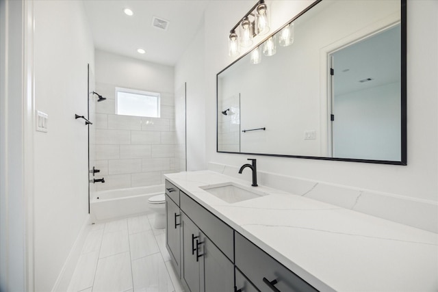 full bathroom featuring tile patterned flooring, tiled shower / bath combo, toilet, and vanity