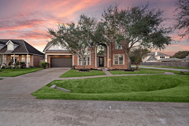 view of front of home featuring a yard and a garage