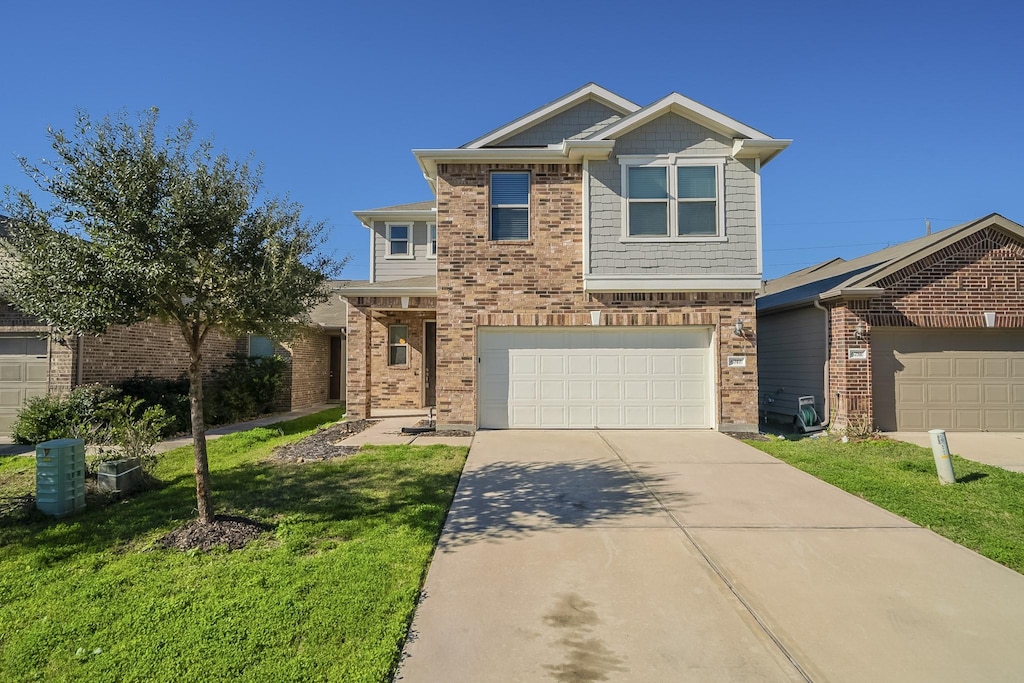 view of front of property with a garage and a front lawn