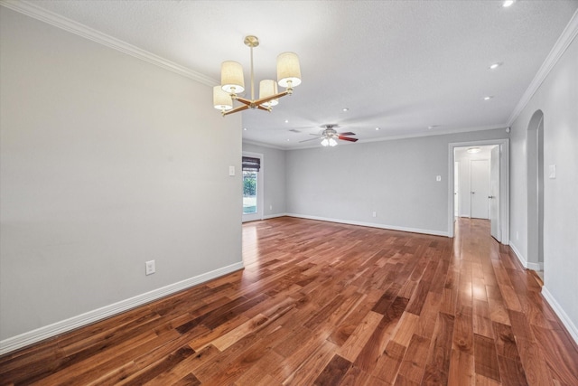 empty room featuring a textured ceiling, crown molding, dark hardwood / wood-style flooring, and ceiling fan with notable chandelier