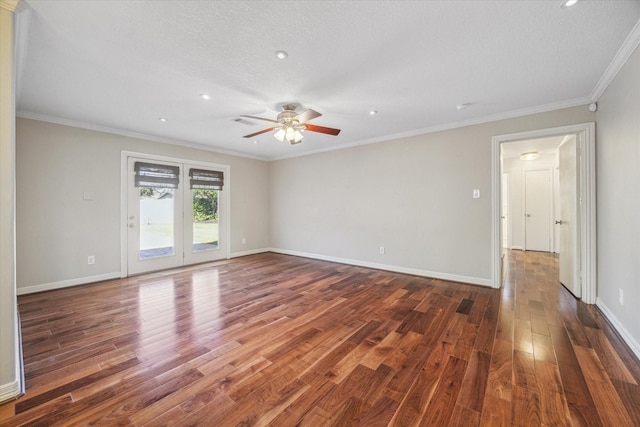 empty room featuring ceiling fan, dark hardwood / wood-style floors, ornamental molding, and a textured ceiling