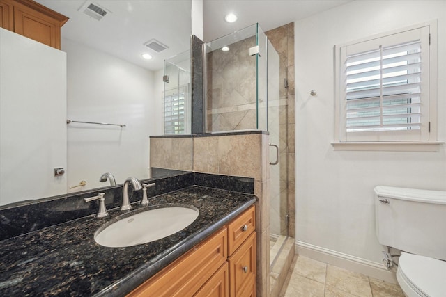 bathroom featuring an enclosed shower, vanity, toilet, and tile patterned floors