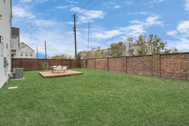 view of yard with a deck and central air condition unit