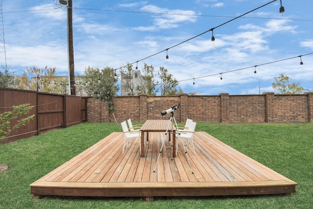 wooden terrace featuring a yard