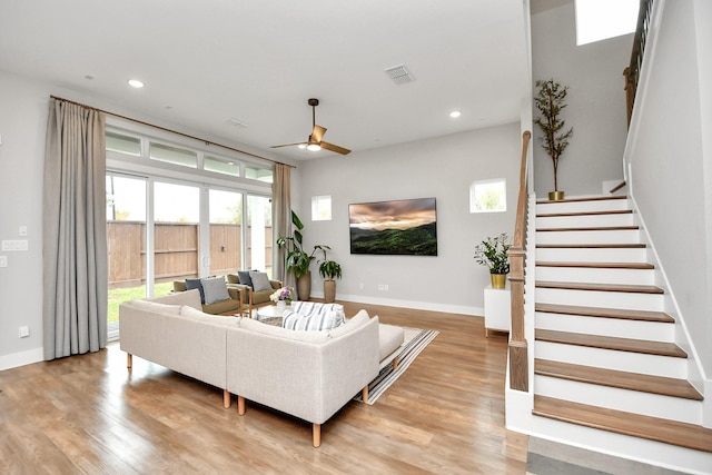 living room featuring ceiling fan and light wood-type flooring