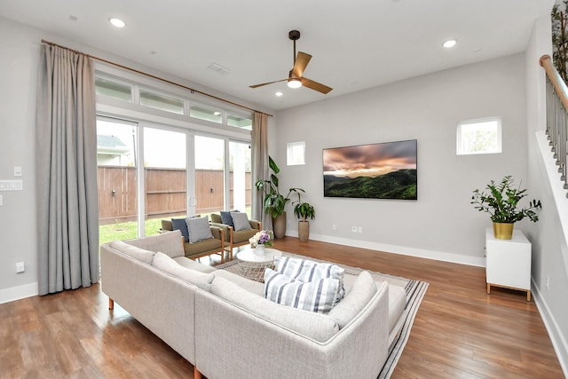 living room with ceiling fan and light wood-type flooring