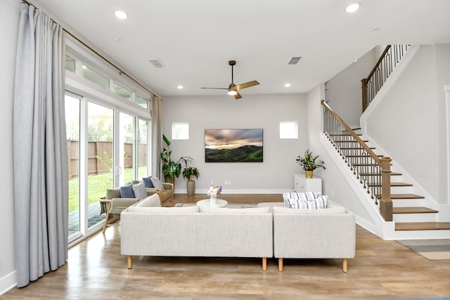 living room featuring light hardwood / wood-style floors and ceiling fan