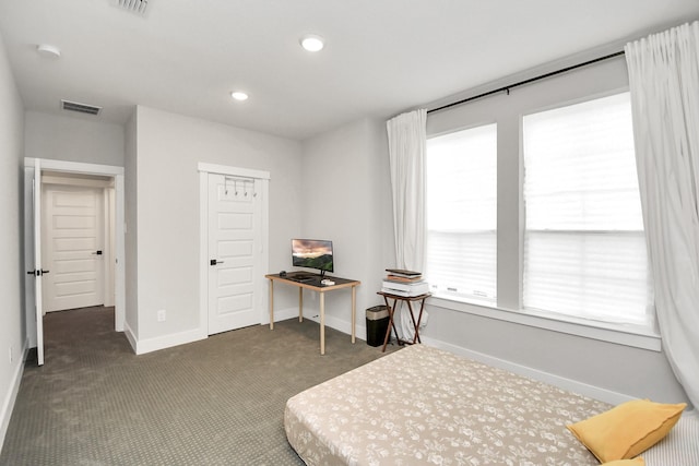 bedroom featuring a closet and dark colored carpet