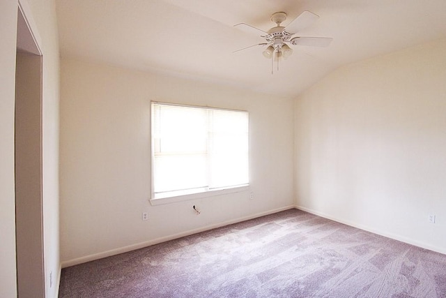 carpeted empty room with vaulted ceiling and ceiling fan