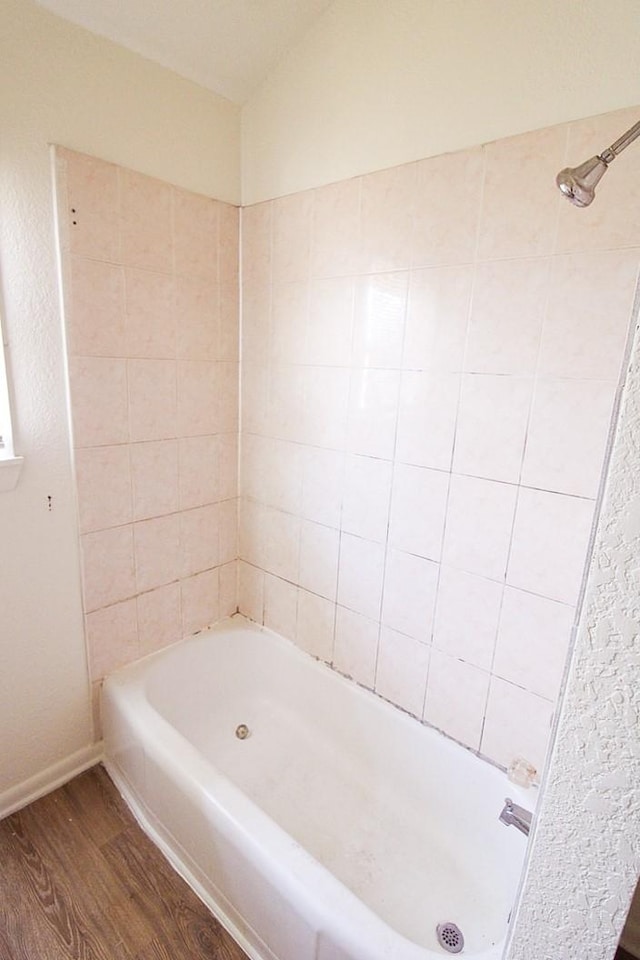 bathroom with wood-type flooring and shower / bathtub combination