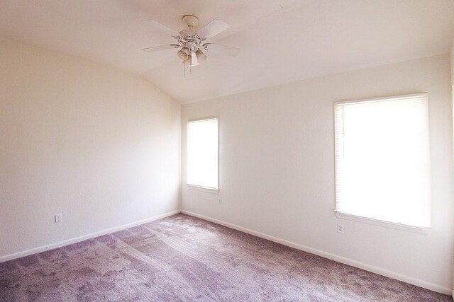 carpeted empty room featuring ceiling fan and vaulted ceiling