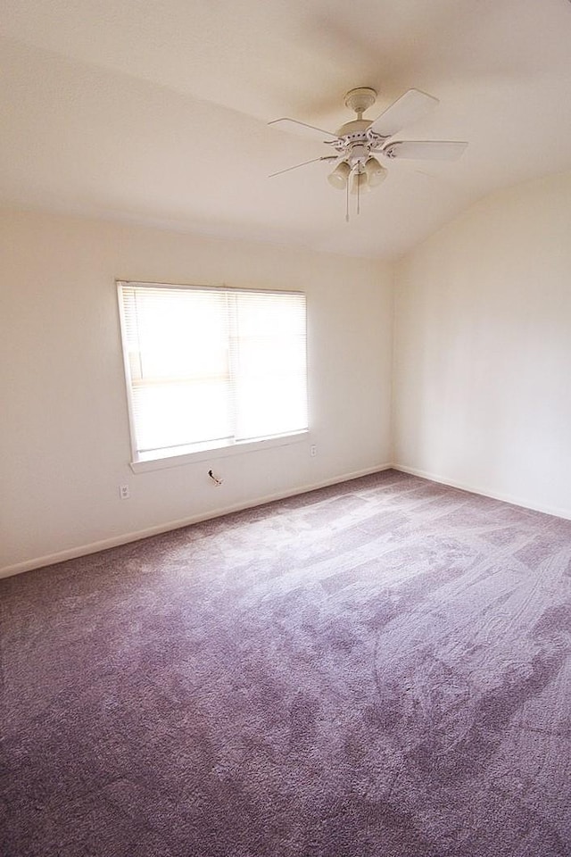 empty room with ceiling fan and carpet floors