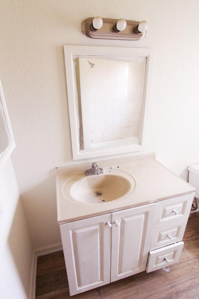 bathroom featuring hardwood / wood-style floors, vanity, and toilet