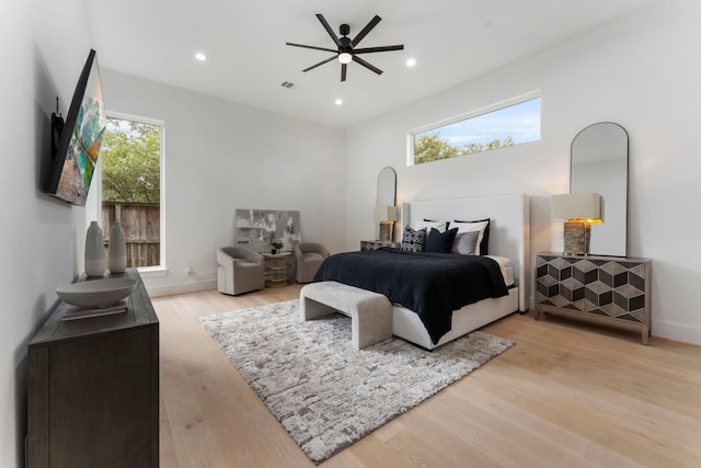 bedroom featuring light hardwood / wood-style flooring and multiple windows