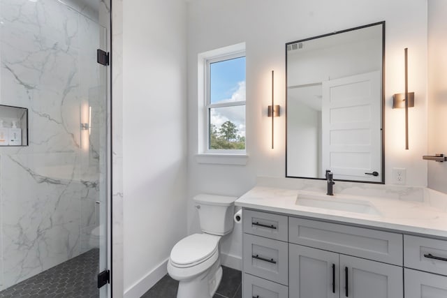 bathroom featuring vanity, toilet, and an enclosed shower