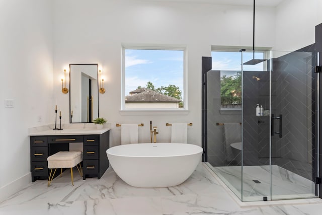 bathroom with vanity, a wealth of natural light, and plus walk in shower