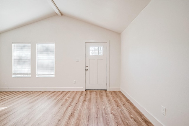 entryway featuring vaulted ceiling with beams, light hardwood / wood-style flooring, and a healthy amount of sunlight