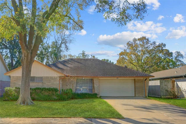 ranch-style home with a front lawn and a garage