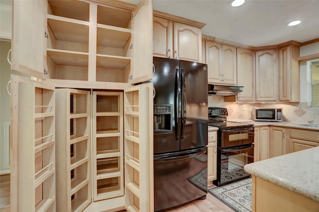 kitchen featuring light brown cabinetry, backsplash, light hardwood / wood-style floors, and black appliances