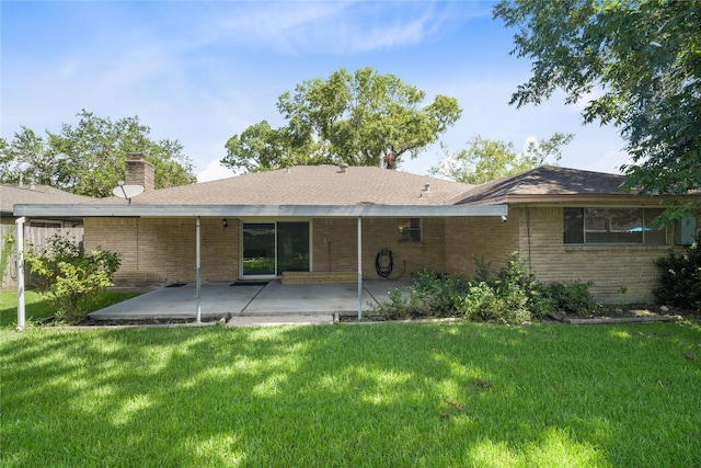 rear view of house featuring a lawn and a patio area