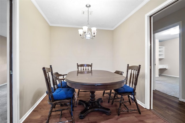 dining area with dark hardwood / wood-style floors, ornamental molding, and an inviting chandelier