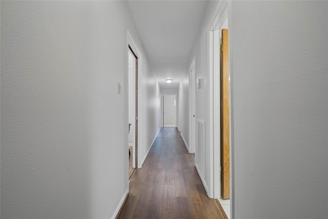 corridor with hardwood / wood-style floors