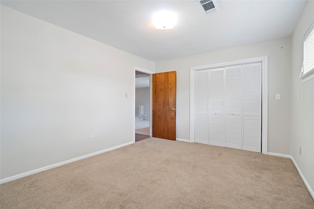 unfurnished bedroom with carpet flooring and a closet