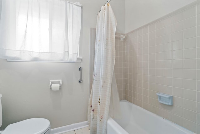 bathroom with shower / tub combo and toilet