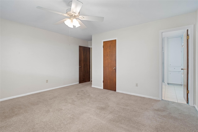 unfurnished bedroom with light carpet and ceiling fan