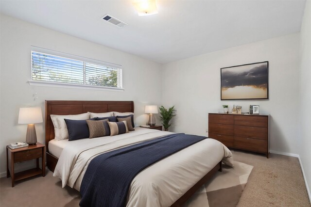 bedroom featuring light carpet