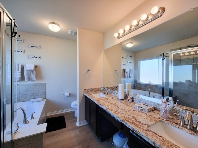 full bathroom featuring shower with separate bathtub, toilet, vanity, and hardwood / wood-style flooring